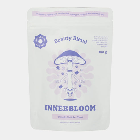 A pouch of Soulshine Spores InnerBloom Beauty Blend, a 100% organic medicinal mushroom powder blend of 100% organic Tremella, Shiitake, and Chaga mushrooms.