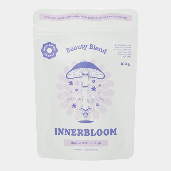 A pouch of Soulshine Spores InnerBloom Beauty Blend, a 100% organic medicinal mushroom powder blend of 100% organic Tremella, Shiitake, and Chaga mushrooms.