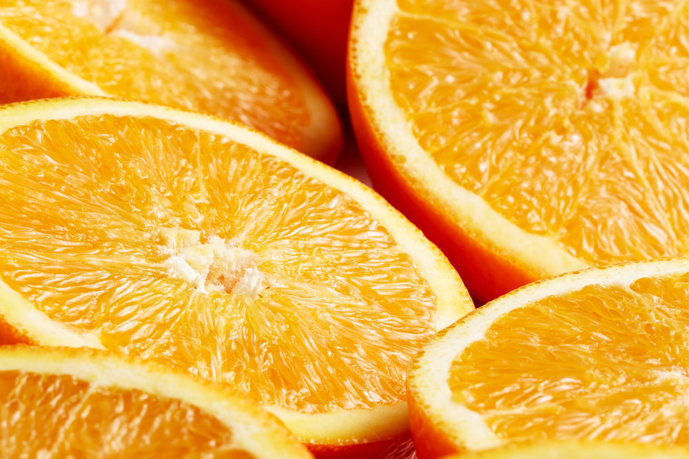 Close-up of fresh orange slices representing Vitamin C (Sodium Ascorbyl Phosphate), a stable and natural brightening antioxidant that evens skin tone, supports collagen and helps reduce pigmentation and sun damage.