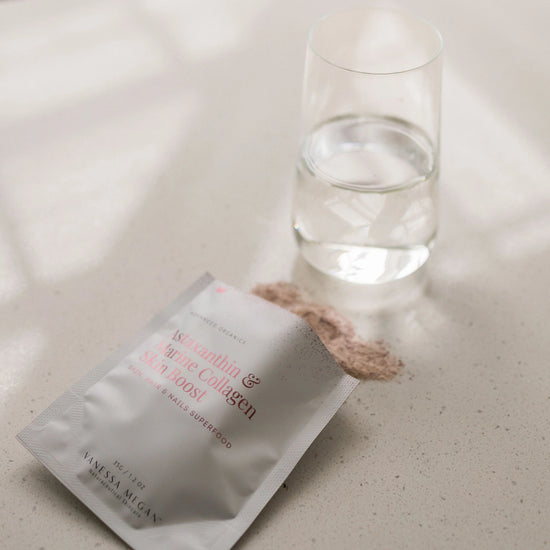 Vanessa Megan Astaxanthin and Marine Collagen Skin Boost powder next to glass of water, showing easy-to-mix daily collagen drink for radiant skin, strong nails, healthy hair & joint support.