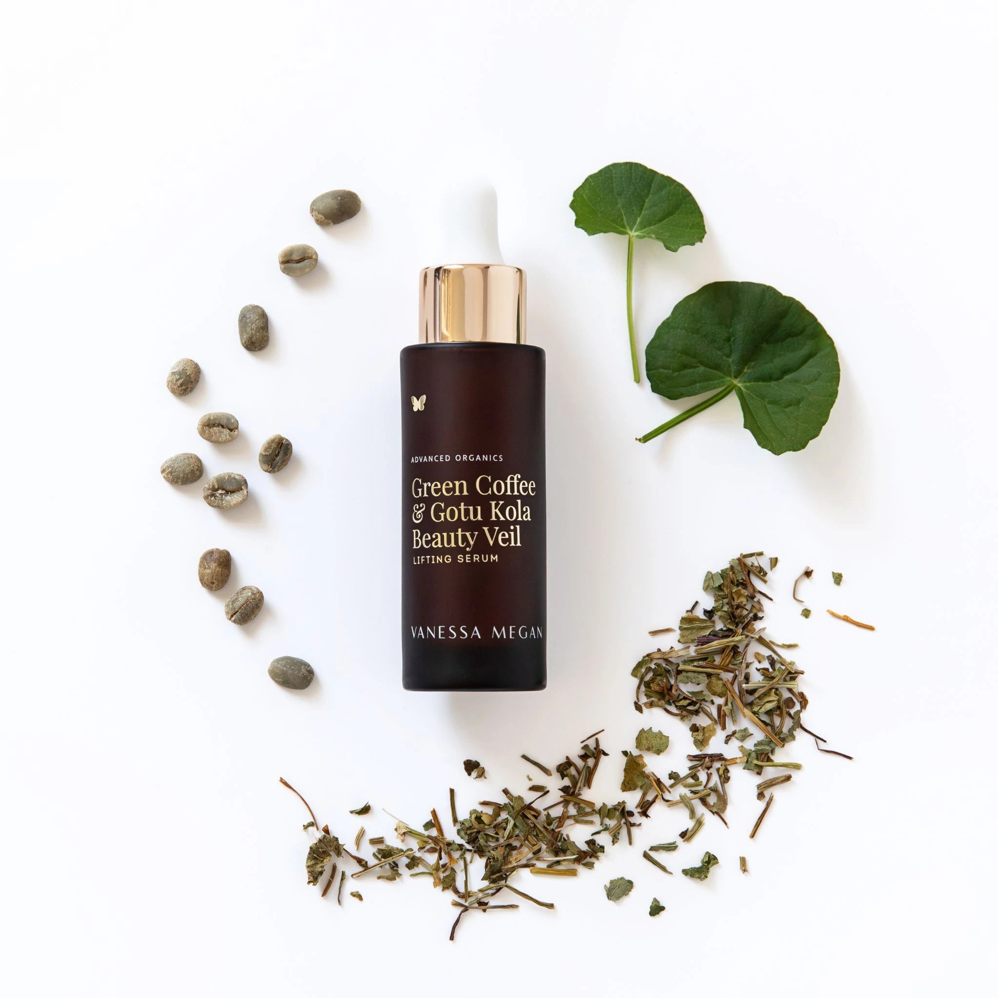 Vanessa Megan Green Coffee & Gotu Kola Beauty Veil serum bottle with green leaves and coffee beans on a white background