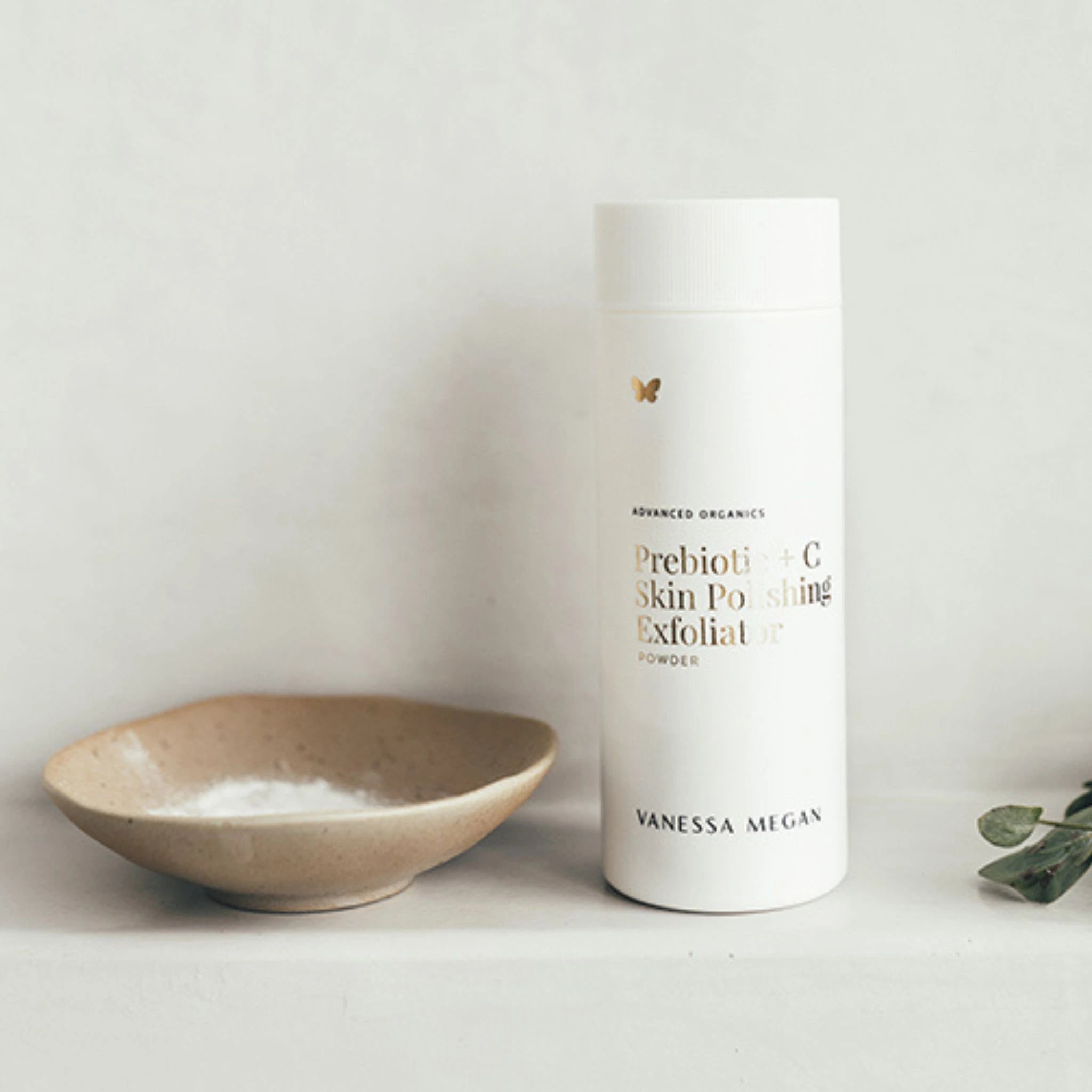 Vanessa Megan Prebiotic + C Skin Polishing Exfoliating Powder 75g in powder dispenser styled with ceramic bowl.