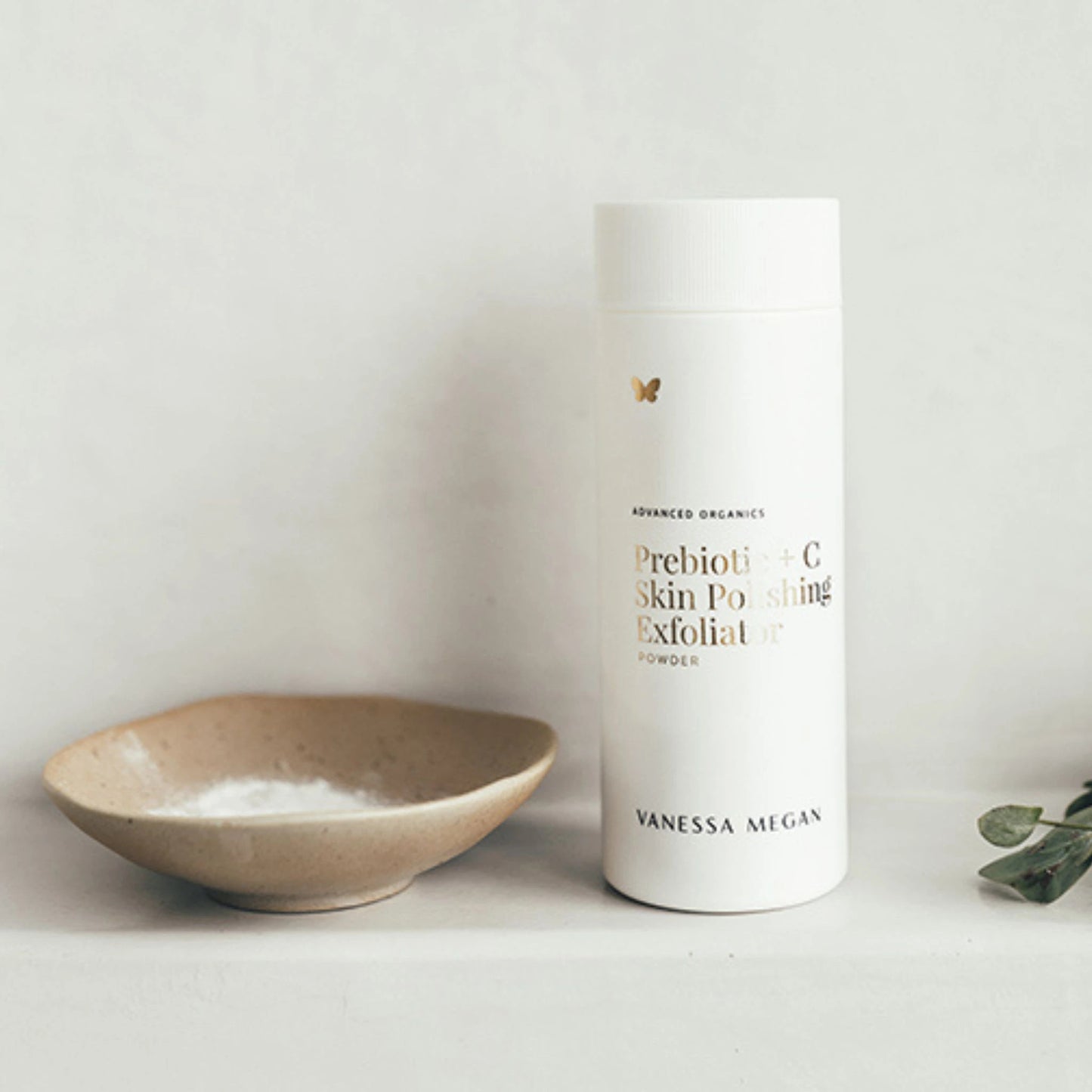 Vanessa Megan Prebiotic + C Skin Polishing Exfoliating Powder 75g in powder dispenser styled with ceramic bowl.