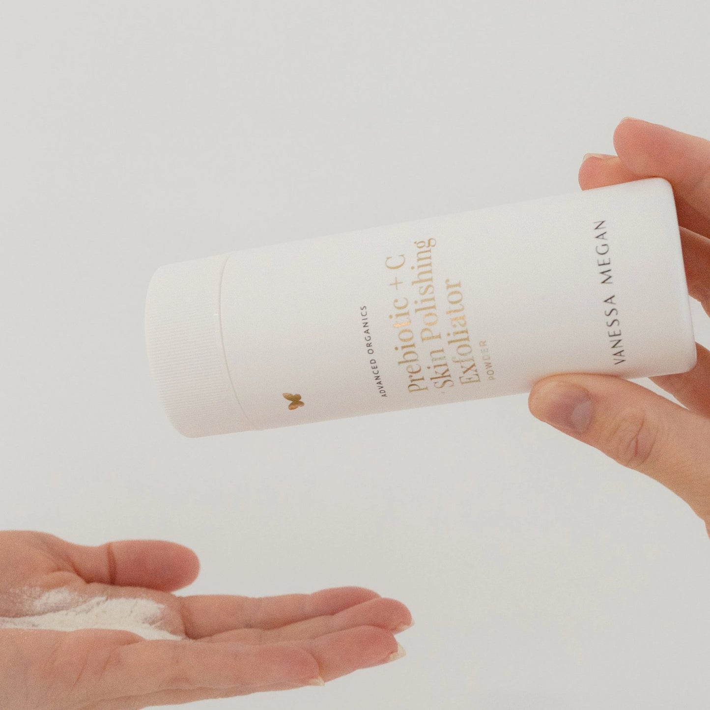 Vanessa Megan Prebiotic + C Exfoliating Powder being dispensed into hand.