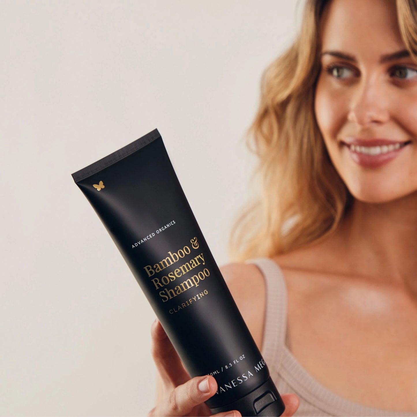 Model holding Vanessa Megan Bamboo and Rosemary Clarifying Shampoo – natural clarifying hair care for oily, congested scalps