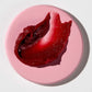 Rich berry-red swatch of Vanessa Megan Glowing Lip & Cheek Tinted Balm showcasing its Rich berry-red creamy, buildable pigment from 100% natural, organic ingredients."