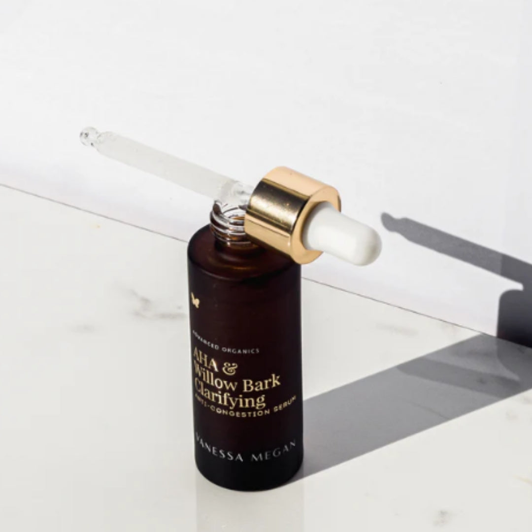 Vanessa Megan AHA and Willow Bark Clarifying Serum open bottle with glass dropper.