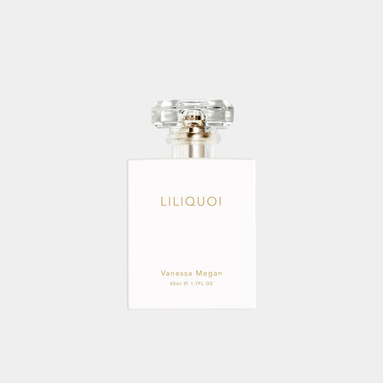 Vanessa Megan Liliquoi 100% Natural Perfume 50ml white bottle with gold lettering captured on a soft grey background.