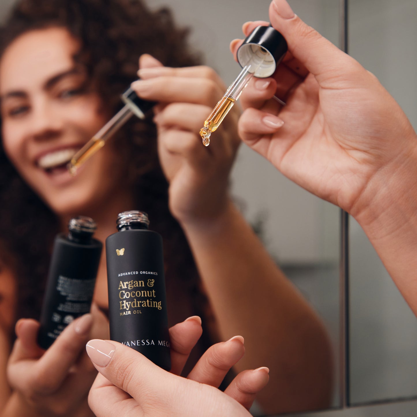 Vanessa Megan Argan and Coconut Hydrating Hair Oil being applied with dropper — nourishing, silicone-free hair oil with organic coconut and argan oil.