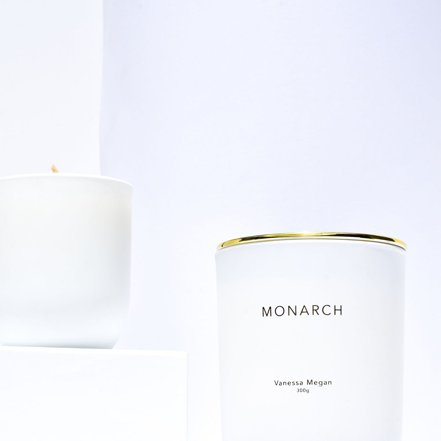 Vanessa Megan Monarch 100% Natural Soy Wax Candle front view with gold cover and rear candle showing cotton wick ready for lighting.
