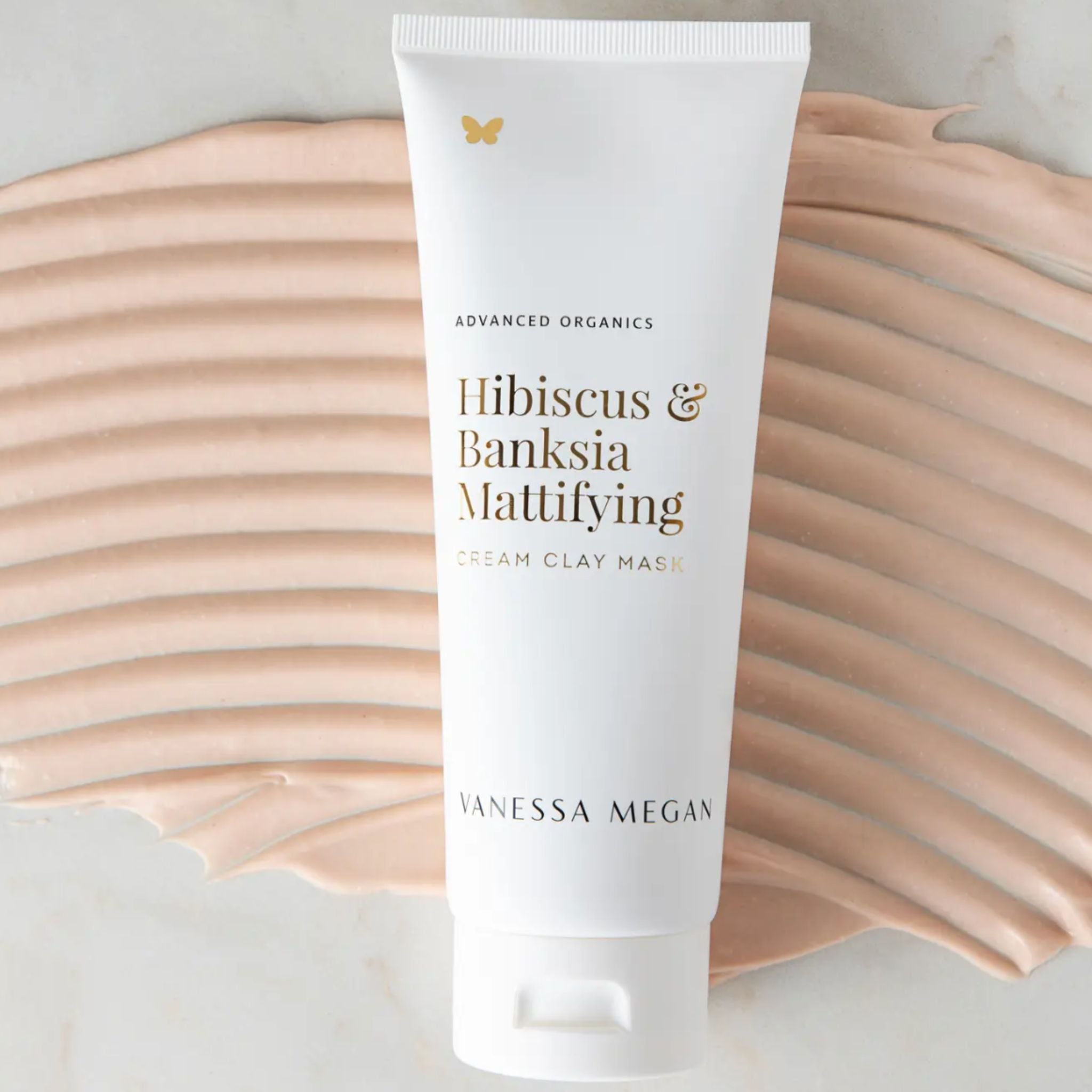 Vanessa Megan Hibiscus and Banksia Mattifying Cream Clay Mask in recyclable sugarcane squeeze tube on clay mask texture background.