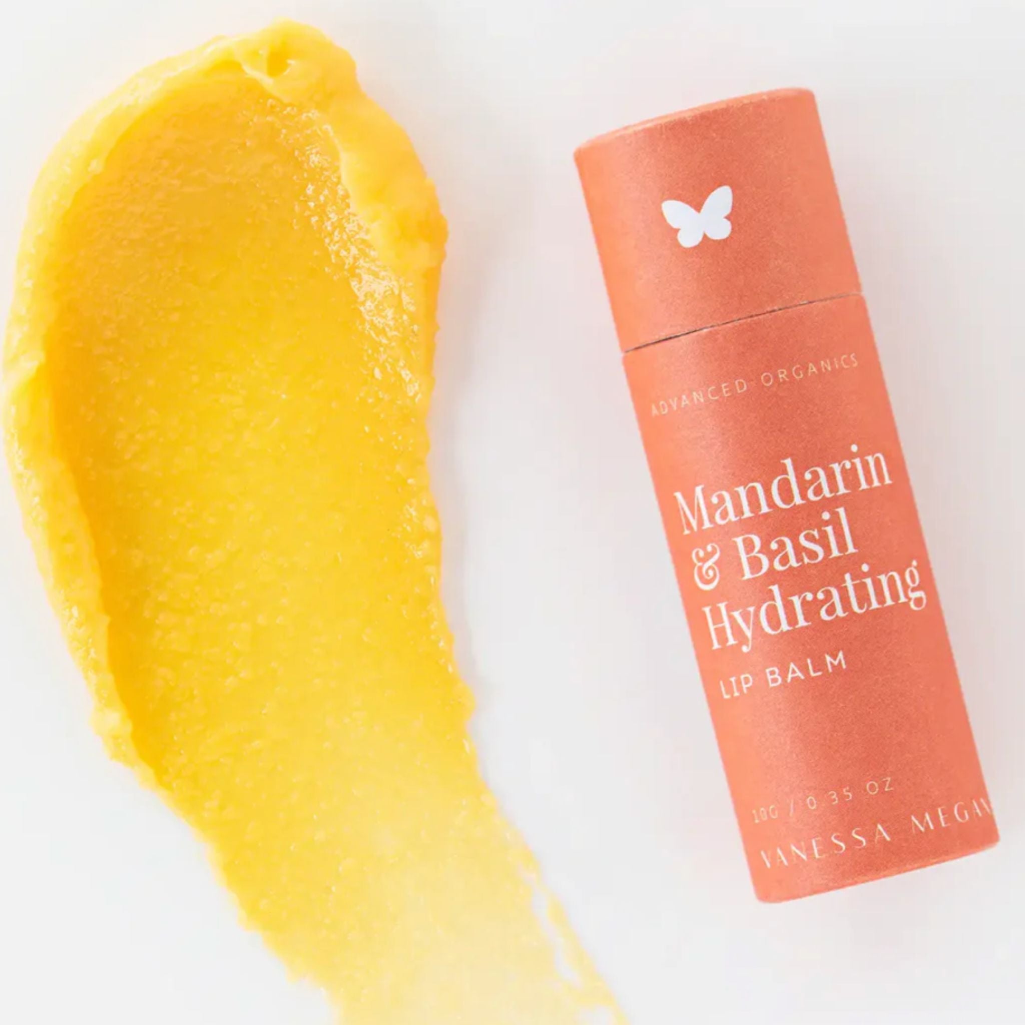 Vanessa Megan Mandarin and Basil Hydrating Lip Balm with balm texture swatch beside its 100% compostable  tube.