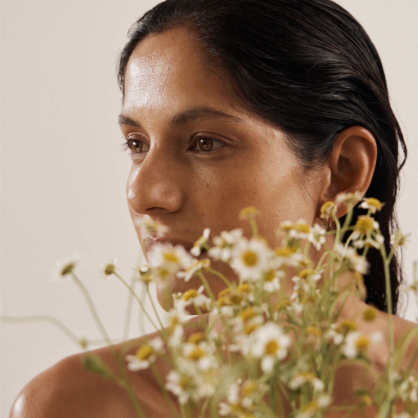 Vanessa Megan skincare campaign model portrait with natural glowing skin and botanical florals.