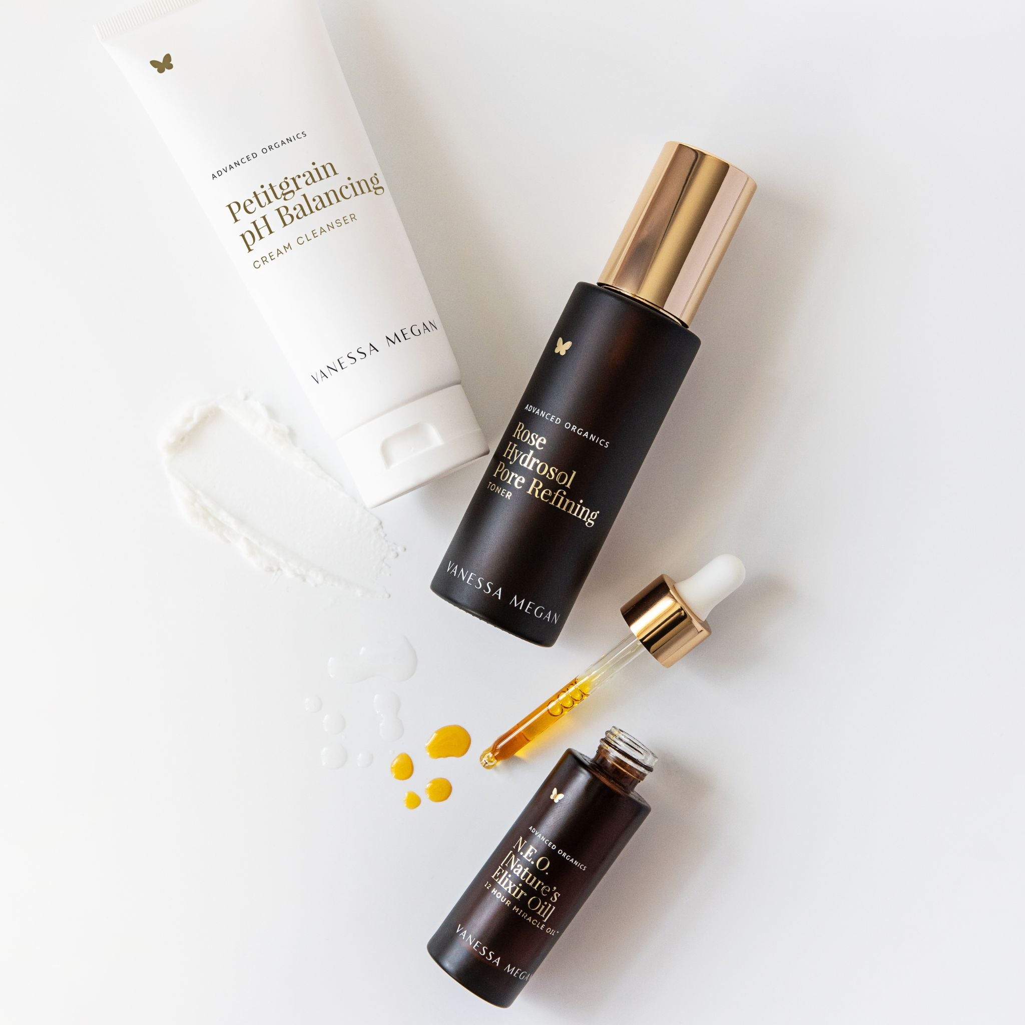 Vanessa Megan N.E.O 12 Hour Miracle Oil with Rose Hydrosol Pore Refining Toner and Petitgrain pH Balancing Cream Cleanser, luxury natural skincare ritual featuring botanical facial oil and glass dropper on a clean white background.