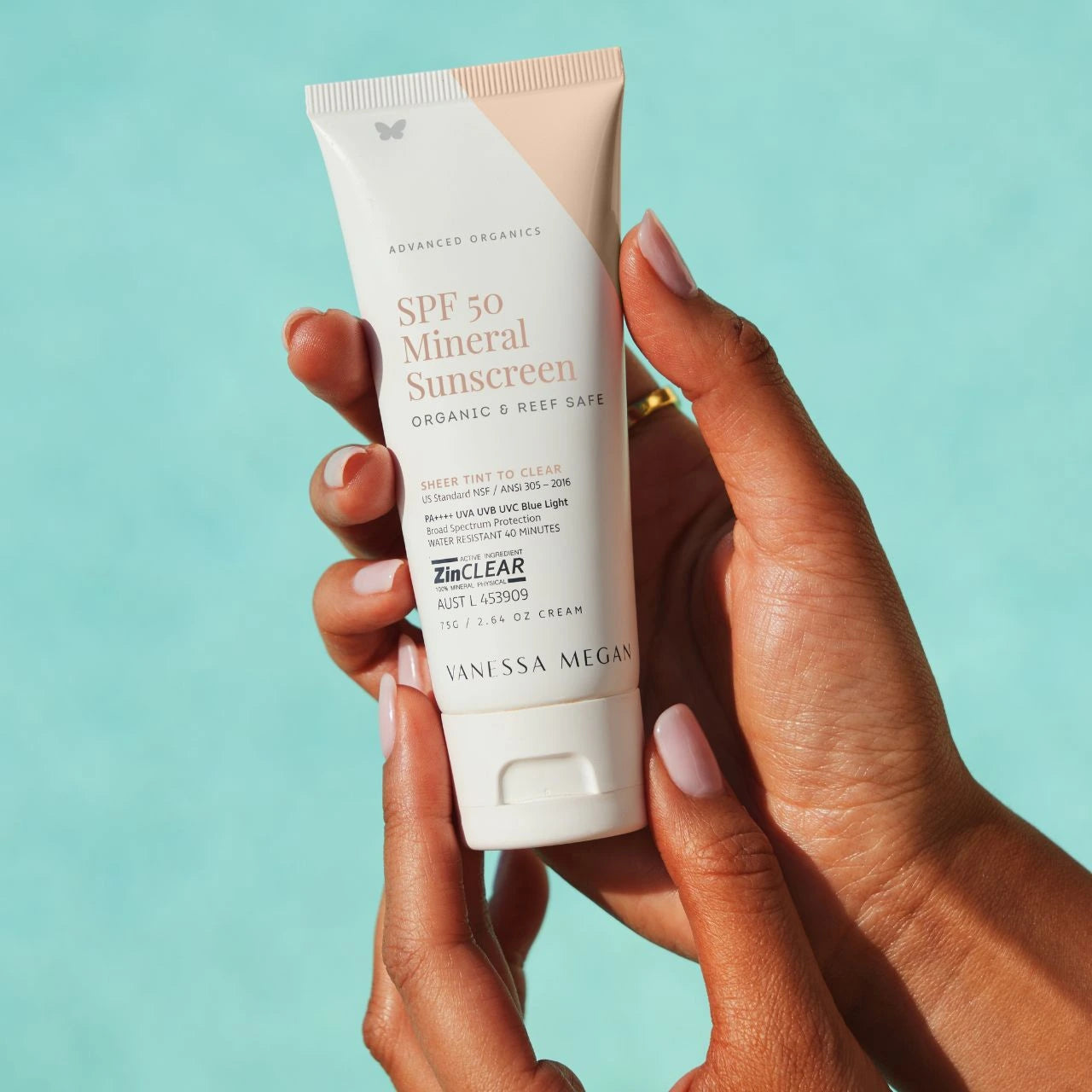 Hands holding Vanessa Megan SPF 50 Mineral Sunscreen—organic, reef-safe, broad-spectrum protection with Zinclear technology, perfect for daily wear and safe sun care.