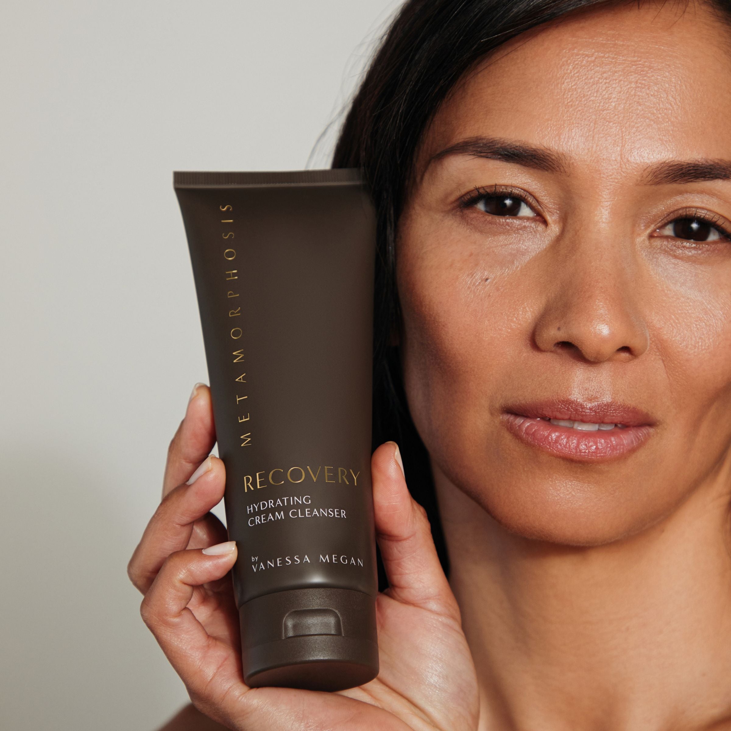 Woman holding Metamorphosis Recovery Hydrating Cream Cleanser by Vanessa Megan, natural skincare for peri to post-menopausal skin, available in NZ at Intentionally Natural.