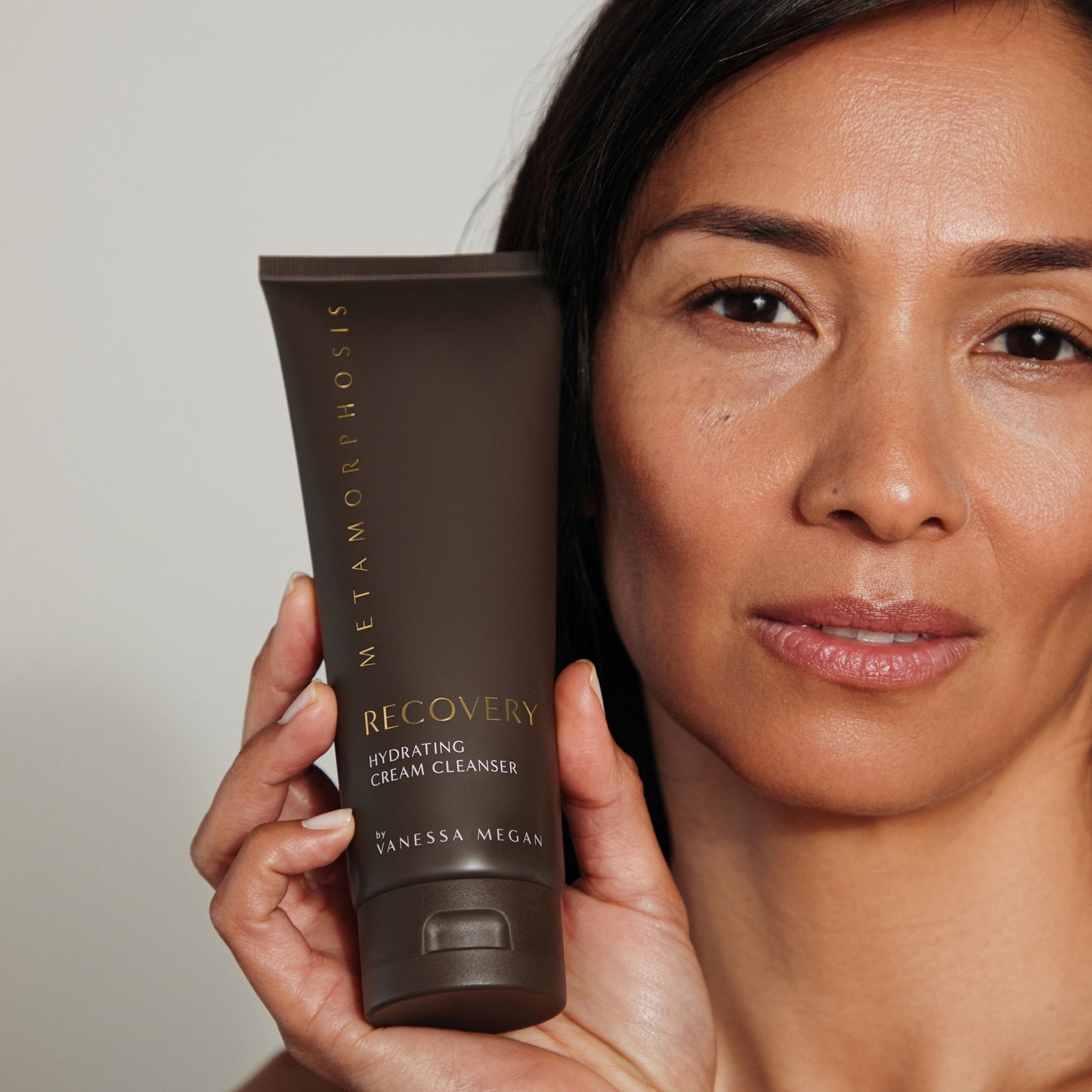 Woman holding Metamorphosis Recovery Hydrating Cream Cleanser by Vanessa Megan, natural skincare for peri to post-menopausal skin, available in NZ at Intentionally Natural.
