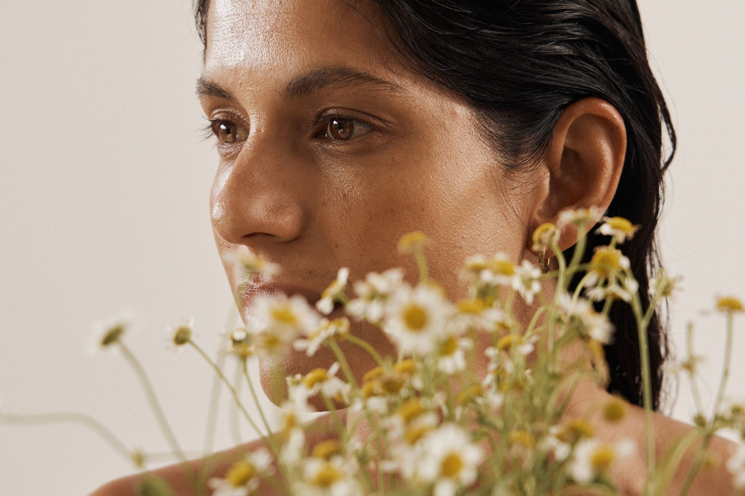 Vanessa Megan skincare campaign model portrait with natural glowing skin and botanical florals.