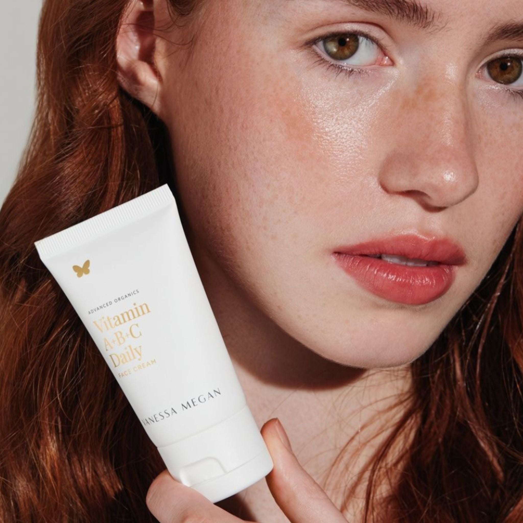 Women holding Vanessa Megan Vitamin A+B+C Daily Face Cream with radiant and hydrated skin with a natural healthy glow.