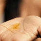 Silky, golden vēr वेर Face Oil in the palm, showcasing its lightweight yet deeply nourishing formula for glowing, healthy skin.