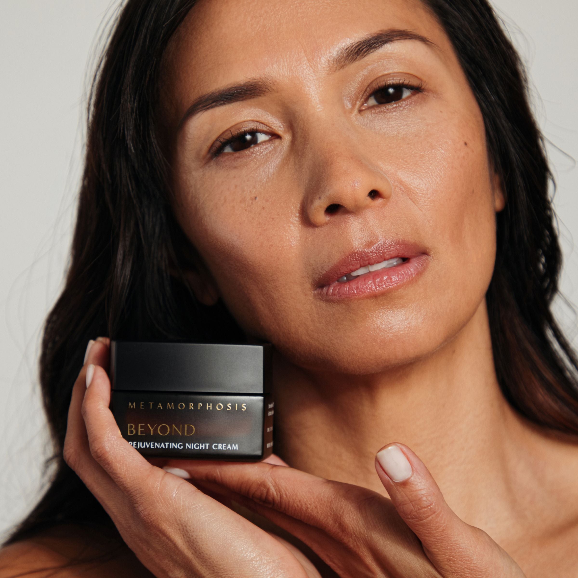 Woman holding Metamorphosis Beyond Rejuvenating Night Cream by Vanessa Megan – natural night cream for peri to post-menopausal skin.